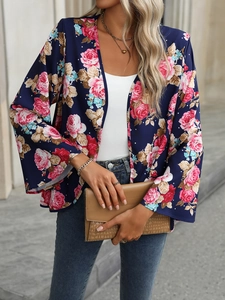 Detail of floral chiffon blouse with pink roses on navy blue background and bell sleeves
