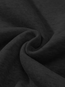 Macro detail of dark charcoal grey knitted fabric showing soft cotton blend texture
