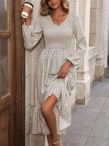 Detail of V-neck floral dress showing smocking waist elastic and star print pattern