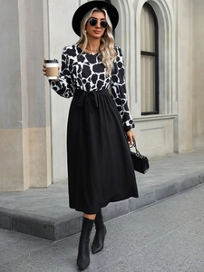 Detail of elegant long sleeve dress with contrast animal print and waist tie bow