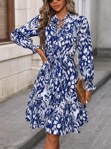 Detail view of floral midi dress with flared sleeves, waist belt and blue abstract pattern