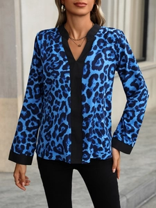 Close-up of leopard print blouse with V-neckline and black contrast trim details