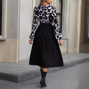 Elegant long-sleeved contrast dress featuring cow print bodice and black A-line midi skirt