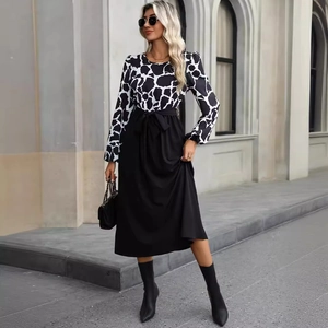 Elegant long sleeve dress with cow print top and black skirt featuring a waist tie