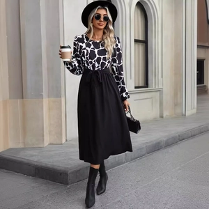 Elegant long sleeve patchwork dress with cow print top and black A-line skirt with belt