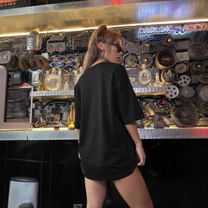 Women's oversized black cotton t-shirt with crew neck and dropped shoulders in cyberpunk studio