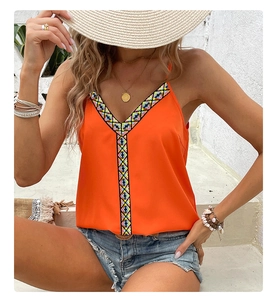 Detail of bohemian orange camisole with colorful geometric embroidery and V-neckline