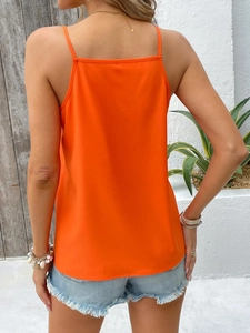 Rear view of an orange spaghetti strap top with a loose fit for summer vacation wear