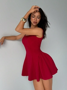 Detail of red mini sleeveless dress with waist pleats and gold metal accessories