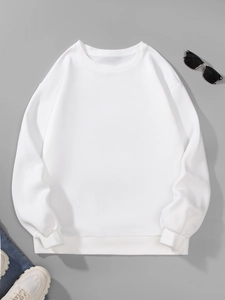 Flat lay of a white crewneck sweatshirt with casual accessories on a grey background