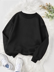 Detail of a black crewneck sweatshirt with ribbed cuffs on white plush background