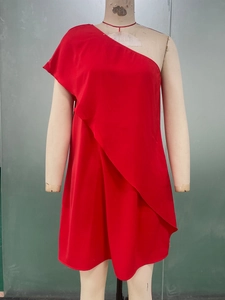 Detail view of red one-shoulder dress featuring layered ruffles on chiffon fabric