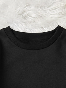 Close-up of the elastic ribbed neckline on a premium black cotton crewneck sweatshirt