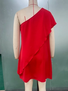 Detailed view of red one-shoulder dress with layered ruffles and asymmetric design