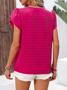 Detail of hot pink ruffled sleeve blouse showing Swiss dot textured fabric from the back