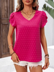 Detail of rose red V-neck shirt featuring textured dot fabric and ruffled sleeve edges