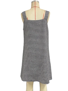 Detailed close-up of a classic black and white houndstooth sleeveless dress on a mannequin