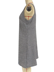 Detailed side view of black and white houndstooth sleeveless dress on a tailor mannequin
