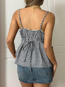Detail of gingham camisole with white lace trim and adjustable back bow tie