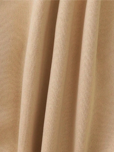 Macro detail of the beige knitted fabric texture on the casual long sleeve sweatshirt