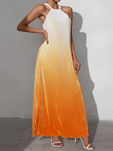 Detail of gradient halter dress showing micro-pleated fabric from cream to orange