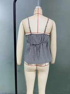 Detail of black and white gingham camisole with lace trim and back tie-up bow