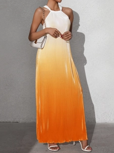Detail of elegant backless halter neck maxi dress with white to orange gradient pleats