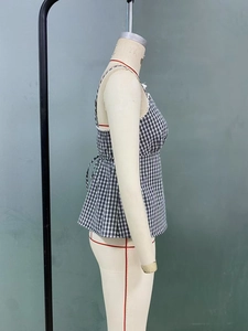 Detail of black and white gingham camisole with side tie-up detail and flared silhouette