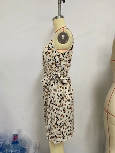 Detail shot of the side lace-up design and leopard print pattern on the floral midi dress