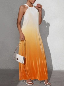 Detail of gradient orange pleated halter dress showing delicate vertical accordion folds