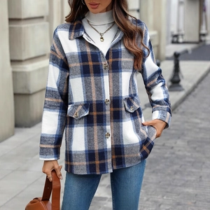 Plaid long sleeve shirt jacket with buttons and pockets shown in an outdoor street setting