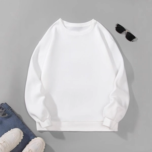 Flat lay of a classic white crewneck sweatshirt styled with jeans and sneakers