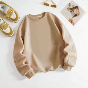 Minimalist beige crewneck sweatshirt in a relaxed fit flat lay with lifestyle props
