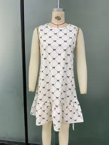 Detail of sleeveless dress with black grid bow pattern and ruffled hemline
