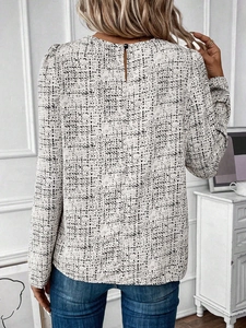 Detail of elegant black and white plaid long sleeve blouse with back button closure