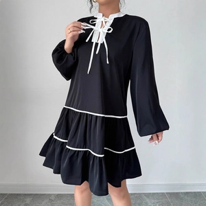 French style long sleeve black dress with white tie collar and tiered skirt detail