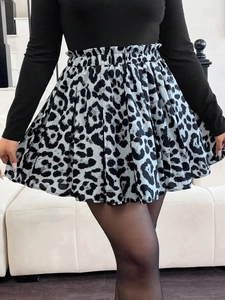 Detail view of high waist leopard print mini skirt with elastic ruched waistband and ruffles