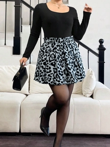 Detail of high waisted black and white leopard print A-line skirt with bubble hem style