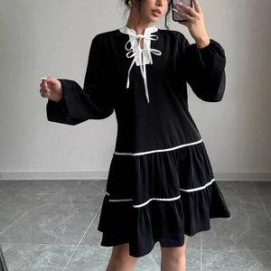 French style long sleeve black tiered dress with white contrast bow tie collar