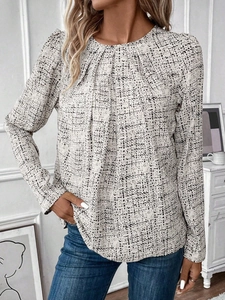 Close-up of gathered neckline detail and subtle textured fabric on long-sleeve blouse
