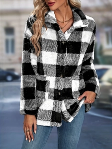 Detailed macro view of black and white plaid faux fur jacket featuring plush fuzzy texture