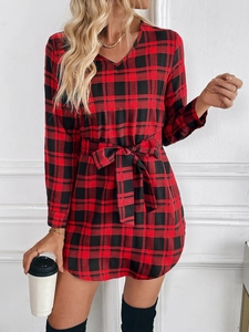 Detail of red and black plaid dress with V-neckline and matching waist tie bow