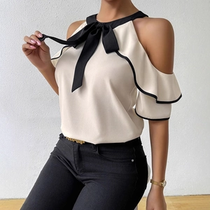 Elegant beige cold-shoulder blouse with black contrast piping and a large neck bow detail