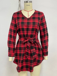Detail of red and black plaid dress with elegant V-neckline and waist tie design