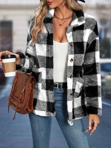 Close-up of black and white checkered fuzzy coat with buttons and lapel collar details