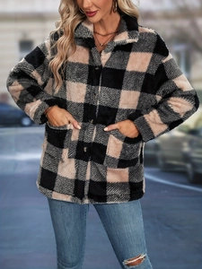 Detailed texture of women's thick plaid flannel jacket with soft fuzzy fabric and buttons