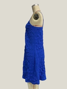 Detail of royal blue pleated fabric texture on a slim fit backless summer maxi dress