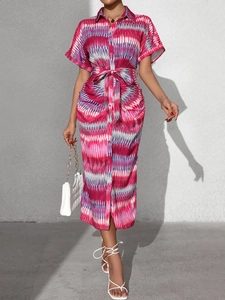 Detail of summer striped shirt dress with waist tie and abstract geometric patterns