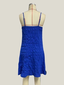 Close-up of royal blue backless dress featuring elastic pleated fabric and texture