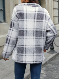Detail view of the thick gray plaid fleece texture on a loose casual winter jacket